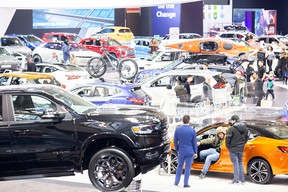 Spectators check out new vehicles at the Canadian International Auto Show in Toronto