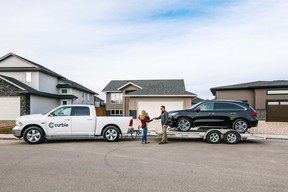 A car delivery service drops off a new vehicle to a prospective buyer