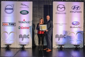 Lorraine Sommerfeld accepting the 2021 AJAC Journalist of the Year award from Jaguar's John Lindo