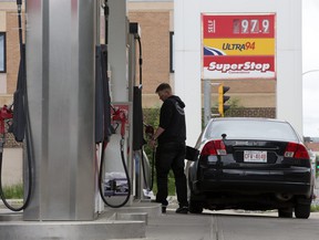 A motorist fills up at a Petro-Canada station in Edmonton on June 27, 2020.