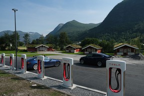 Tesla cars stand at a Tesla Supercharger charging station on August 12, 2020 in Skei, Norway.